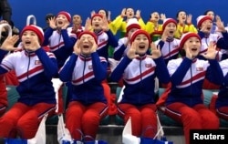 North Korean cheerleaders watch a women's ice hockey match between Korea and Japan in Gangneung, South Korea, February 14, 2018.