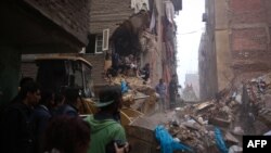 Egyptian rescue workers and residents search for survivors in the rubble of a collapsed building, Nov. 25, 2014 in Cairo's northern district of Matariya. 