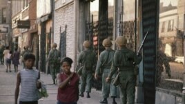 FILE - In this April 6, 1968 file photo, National Guard patrol the streets in Chicago, following rioting and violence that ensued after the news of the assassination of Dr. Martin Luther King, Jr. (AP Photo/File)