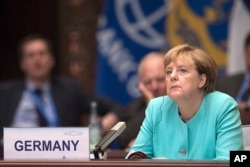 FILE - German Chancellor Angela Merkel listens to Chinese President Xi Jinping's speech during the opening ceremony of the G20 Leaders Summit in Hangzhou, Sept. 4, 2016.