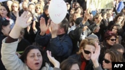 Women gesture during a protest in Tunis, January 29, 2011