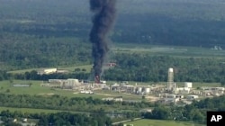 Smoke rises from a chemical plant in Crosby, near Houston, Texas, Sept. 1, 2017. Thick black smoke and towering orange flames shot up Friday from the flooded Houston-area chemical plant after two trailers of highly unstable compounds blew up a day earlier.