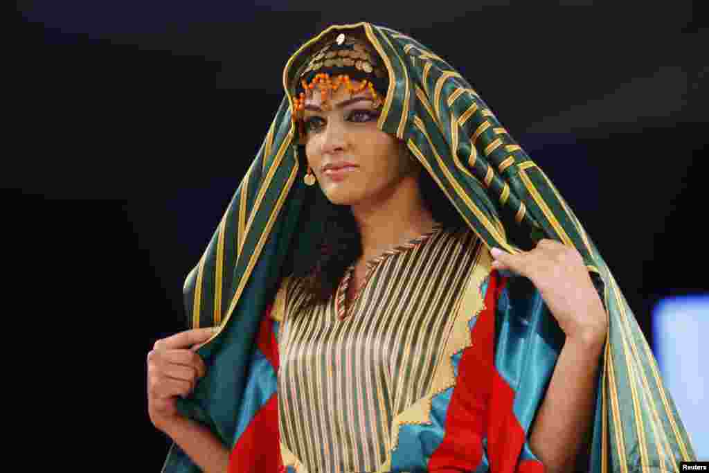 A model presents a Bedouin dress creation by Society for the Development and Rehabilitation for the Rural Woman (SDRRW), during their show in Amman November 8