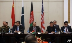 FILE - Afghan Foreign Minister, Salahuddin Rabbani, center, starts the meeting to discus a road map for ending the war with the Taliban at the Presidential Palace in Kabul, Afghanistan, Monday, Jan. 18, 2016.