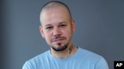 FILE - Puerto Rican rapper Residente, founder of the group Calle 13, poses for a portrait in New York, Nov. 9, 2017.