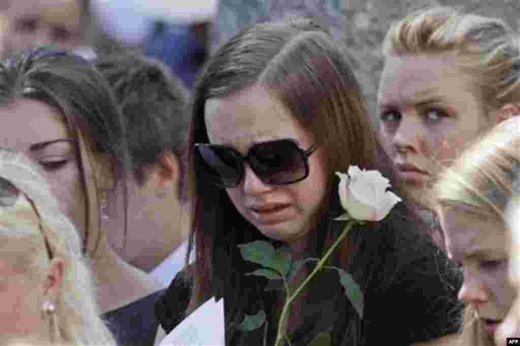 A mourner weeps during the funeral service for Bano Abobakar Rashid, 18, the first victim of the shooting rampage at Utoeya to be buried, at a church in Nesodden, near Oslo, Norway, Friday July 29, 2011. Rashid, whose family fled to Norway from Iran in