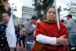 Supporters of the peace accord signed between the Colombian government and rebels of the Revolutionary Armed Forces of Colombia, FARC, follow on a giant screen the results of a referendum to decide whether or not to support the peace accord in Bogota, Colombia, Sunday, Oct. 2, 2016.