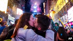 Irene Mayoral and Gerald Nuell of Spain kiss in Times Square in New York shortly after midnight Jan. 1, 2022, as they attend New Year's Eve celebrations. The couple became engaged Friday. 