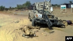 Bodies appearing to be those of rebel-soldiers allied to former vice president Riek Machar beside wrecked military vehicle, Bor, Dec. 28, 2013.