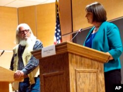 FILE - In this Oct. 5, 2016, photo, Libertarian Party candidate Rick Breckenridge, left, looks on during a debate with Democratic U.S. House candidate Denise Juneau in Great Falls, Mont. Breckenridge, who is running for U.S. Senate this year, endorsed Republican candidate Matt Rosendale in his race in response to an anonymous mailer that seeks to undermine conservative support of Rosendale.