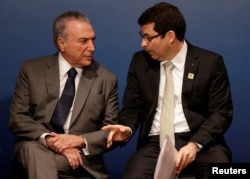 Brazil's President Michel Temer speaks with Banco do Brasil CEO Paulo Rogerio Caffarelli, right, during a ceremony to launch the "Simpler Undertakings" Program in Brasilia, March 15, 2017.