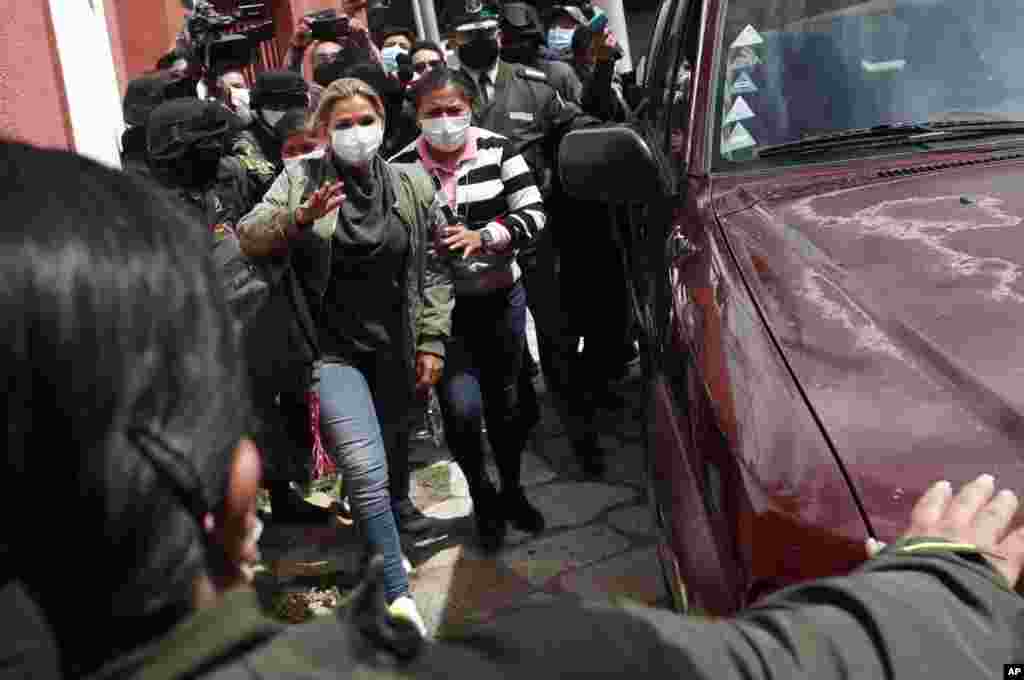 Bolivia&#39;s former interim President Jeanine Áñez is escorted into a prison in La Paz.&nbsp; A judge ordered Áñez held for four months in preventative detention following her arrest on charges linked to the 2019 ouster of former President Evo Morales, which his supporters consider a coup détat.