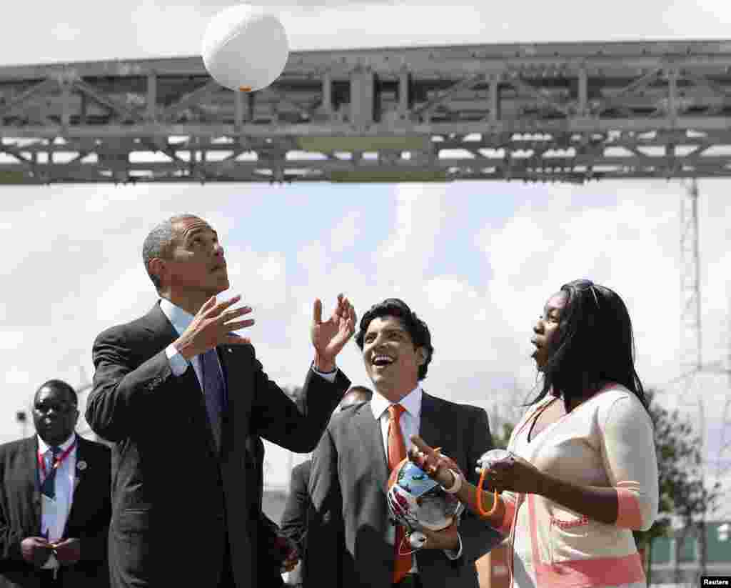 U.S. President Barack Obama heads a soccer ball at Ubungo Power Plant in Dar es Salaam, July 2, 2013. The ball called a &quot;soccket ball&quot; has internal electronics that allows it to generate and store electricity that can power small devices. 