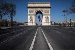 A french flag is under the Arc de Triomphe, on March 19, 2020 in Paris, as a strict lockdown is in effect in France to stop the spread of COVID-19, caused by the novel coronavirus.