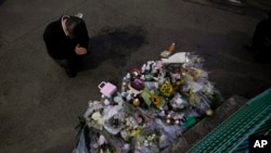A man pays respects at a makeshift memorial for the victims of a knife attack, May 28, 2019, in Kawasaki, just outside Tokyo.