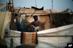 FILE - Christian refugees create a home for themselves in makeshift shelters near the airport in Bangui, Central African Republic, Jan. 28, 2014.