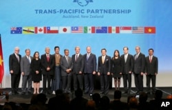 FILE - Trade delegates pose for a photograph after signing the Trans-Pacific Partnership Agreement in Auckland, New Zealand, Feb. 4, 2016.