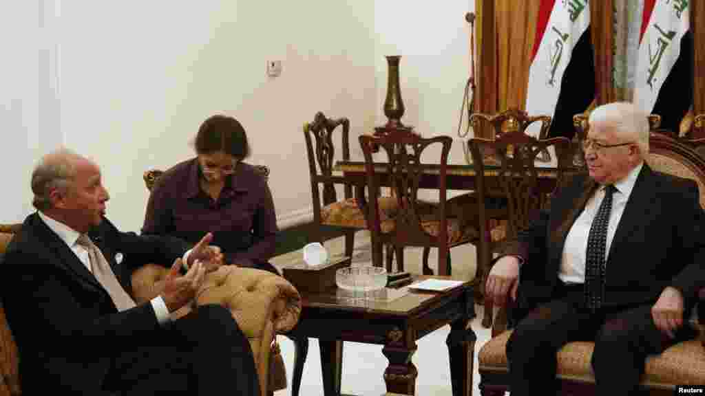 Iraq's newly elected president Fouad Masoum, right, meets with French Foreign Affairs Minister Laurent Fabius in Baghdad, Iraq, Aug. 10, 2014. 