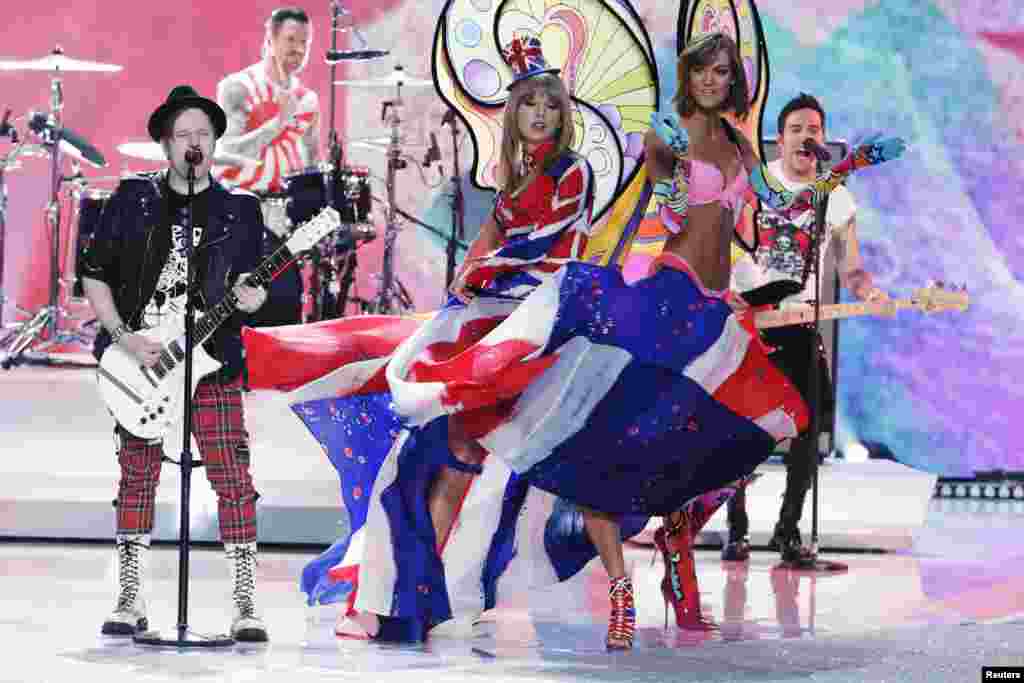 Singer Taylor Swift reacts with model Karlie Kloss as they perform with rock band Fall Out Boy during the annual Victoria&#39;s Secret Fashion Show in New York, Nov. 13, 2013. 