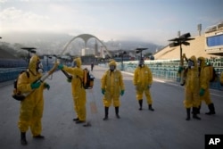 Health workers get ready to spray insecticide to combat the Aedes aegypti mosquitoes that transmit the Zika virus under the bleachers of the Sambadrome in Rio de Janeiro in January 2016. (AP Photo/Leo Correa)