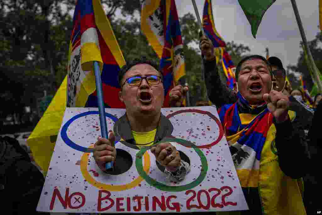 Exiled Tibetans shout expressions as they march toward the Chinese embassy during a protest against the Beijing Winter Olympic Games, in New Delhi, India.