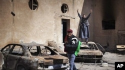 Libyan anti-regime demonstrators at a burned police station in Tobruk, February 25, 2011