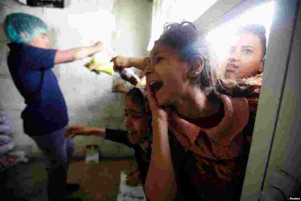 A girl shouts at a charity kitchen, which gives free food rations for the poor, in Sanaa, Yemen.