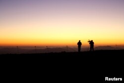 Members of the media work during the opening ceremony of the construction of The Giant Magellan Telescope (GMT) at Las Campanas hill near Vallenar town, Chile, Nov. 11, 2015.