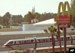 The monorail, which encircles Disneyland in Anaheim, Calif., makes its way past a McDonald's restaurant outside the amusement park Thursday, May 23, 1996.