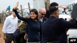 U.S. Ambassador to the U.N., Nikki Haley waves toward Internally Displaced People (IDP) while she is being evacuated by her protection force, following a demonstration in Juba, South Sudan, Oct. 25, 2017.