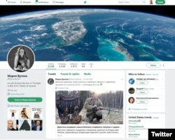 Posts are seen on Maria Butina's Twitter page. Butina has been arrested on charges of conspiring to act as an agent of the Russian government in the U.S. without notifying the attorney general.