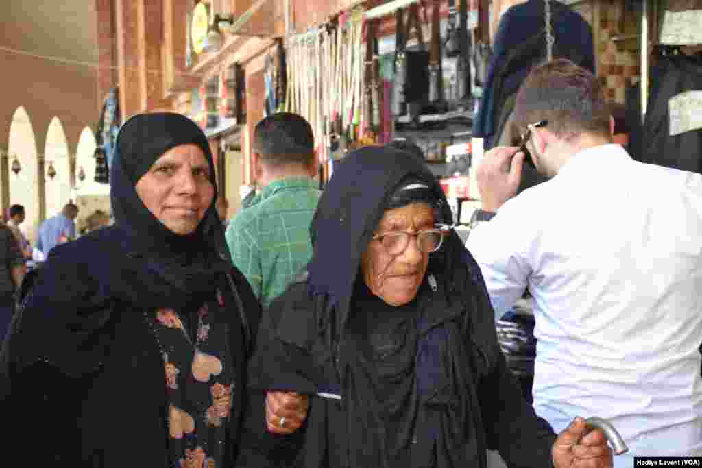 Inside the historic souq, it is possible to see people with traditional and more modern clothing intermingling, in Irbil, Iraq.