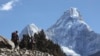 FILE - Trekkers make their way to Dingboche, a popular Mount Everest base camp, in Pangboche, Nepal, Feb. 19, 2016.