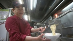 Chef Hung cooks pineapple beef noodle at his restaurant in Taipei, Taiwan, Wednesday, March 10, 2021. (AP Photo/Chiang Ying-ying)