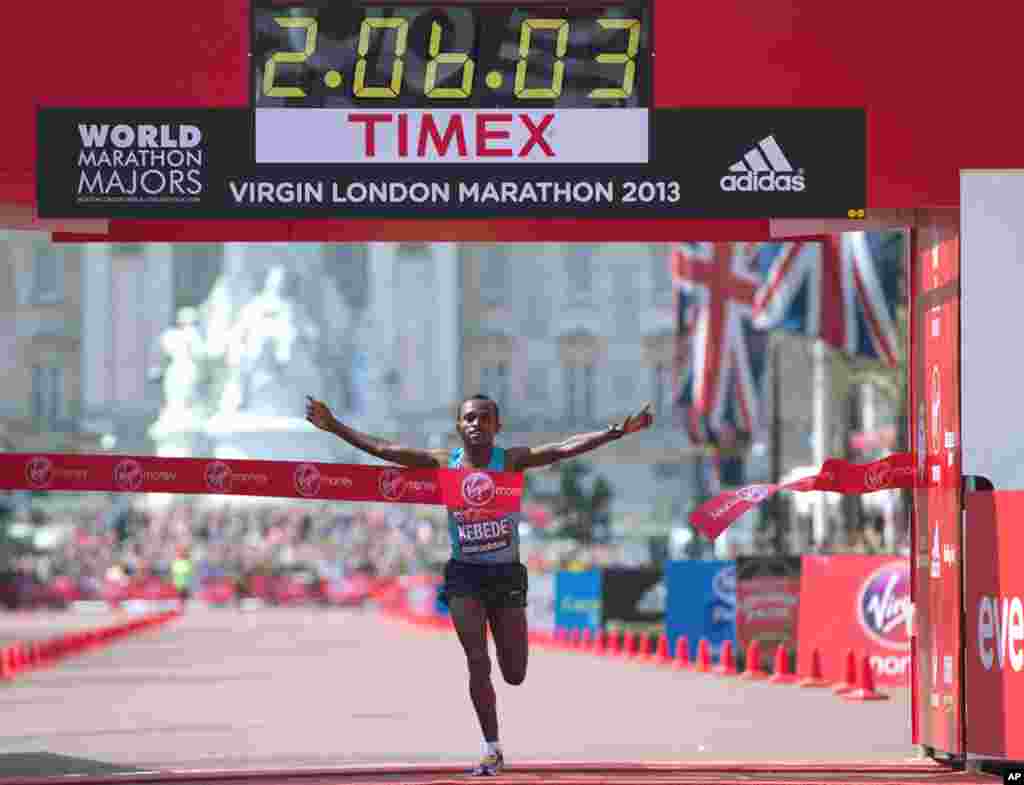 Tsegaye Kebede of Kenya crosses the line to win the men's London Marathon, April 21, 2013. A defiant, festive mood prevailed in London, despite concerns raised by the recent attacks on the Boston Marathon.