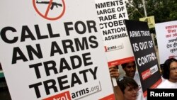 Activists campaigning for a global arms trade treaty hold placards during a protest in New Delhi, India, Sept. 13, 2006.