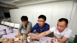 Han Liqun (C), a HR manager of RenRen Credit Management Co., drinks with his colleagues Kou Meng (L) and Ma Zhenguo after finishing work, after midnight, in Beijing, China, April 27, 2016. Office workers sleeping on the job is a common sight in China,...