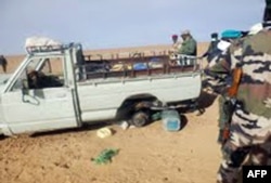 FILE - A picture taken with a mobile phone Oct. 30, 2013 and received on Nov. 2, 2013 shows one of the trucks that was carrying some of 92 migrants who died of thirst in the harsh Niger desert, about a dozen kilometers from the Algerian border.
