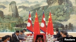 Chinese President Xi Jinping (2nd-R) meets Nepal Prime Minister Khadga Prasad Sharma Oli (2nd L) at the Great Hall of the People in Beijing, China March 21, 2016.