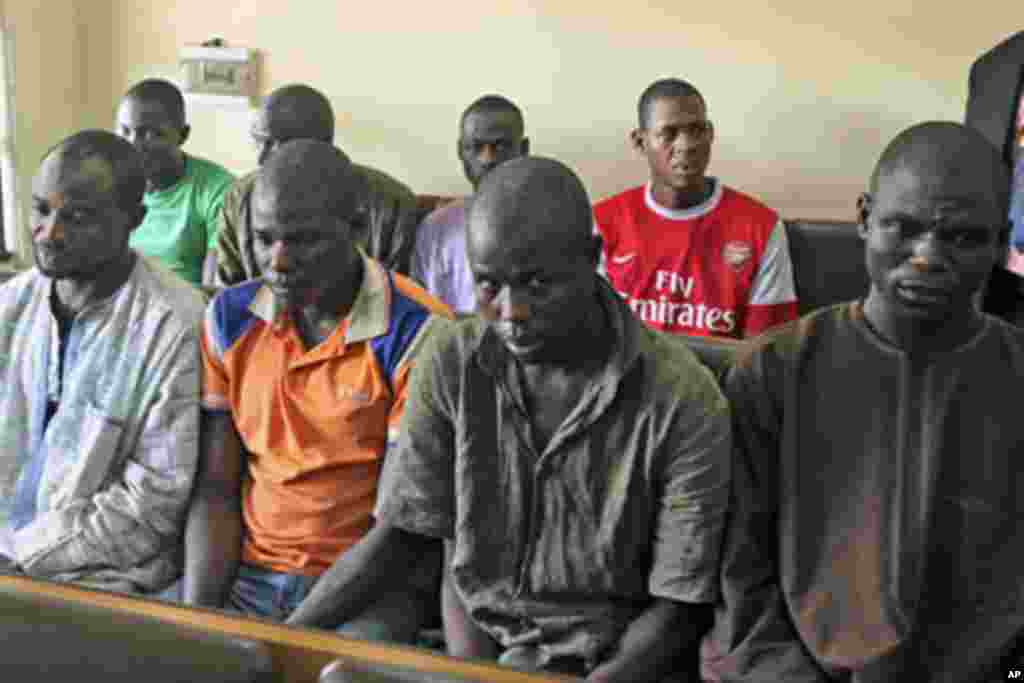 Men believed to be members of Islamist sect Boko Haram are suspected of being involved in a series of bomb attacks, wait for the start of a court session at the Wuse magistrate court in Nigeria's capital Abuja, September 13, 2011.