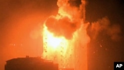 In this image taken from video an explosion hits the media complex that houses the offices of Hamas-run Al Aqsa television and radio in central Gaza City, July 29, 2014. 