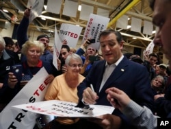 Republican presidential candidate, Sen. Ted Cruz, R-Texas, signs posters for his supporters at a campaign rally in Rochester, New York, April 15, 2016.