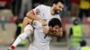 Egypt's Mohamed Salah celebrates with Ahmed Hegazi after winning the penalty shootout against Ivory Coast in Cameroon, Jan. 26, 2022.
