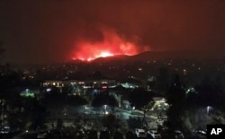 The Hill wildfire burns in the predawn hours on Nov. 9, 2018, seen from Agoura Hills in Southern California.