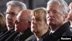 (R-L) German Pres. Joachim Gauck, Chancellor Angela Merkel and Norbert Lammert, Pres. of Germany's lower house of parliament Bundestag attend a service at Berlin's Memorial church to commemorate the 12 killed victims of a truck that ploughed into a crowded Christmas market at Breitscheidplatz, Berlin, Dec. 20, 2016.