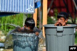 FILE - Rohingya refugees from Myanmar bathe at a makeshift camp in Lhokseumawe, Indonesia's Aceh province, Jan. 13, 2022.