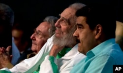 Cuban Leader Fidel Castro, center, attends a gala for his 90th birthday, Aug. 13, 2016, accompanied by Cuba's President Raul Castro, left, and Venezuela's President Nicolas Maduro, right, at the Karl Marx theater in Havana, Cuba.