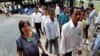 Cambodians enter the court entrance before a delivering verdict of two surviving leaders Khieu Samphan and Noun Chea, at the U.N.-backed war crimes tribunal in Phnom Penh, Cambodia, Thurdday, Aug. 7, 2014. Three and a half decades after the genocidal rule