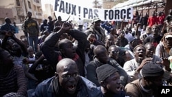 Senegalese anti-government youth rally against President Wade in the capital Dakar. Members of a Senegalese anti-government youth movement Y En A Marre (We're Fed Up) chant slogans during a rally against President Abdoulaye Wade in the capital Dakar, Janu