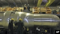 Workers work in a part of the electricity generating plant of the Bushehr nuclear power plant, just outside the southern city of Bushehr, Iran, 26 Oct 2010